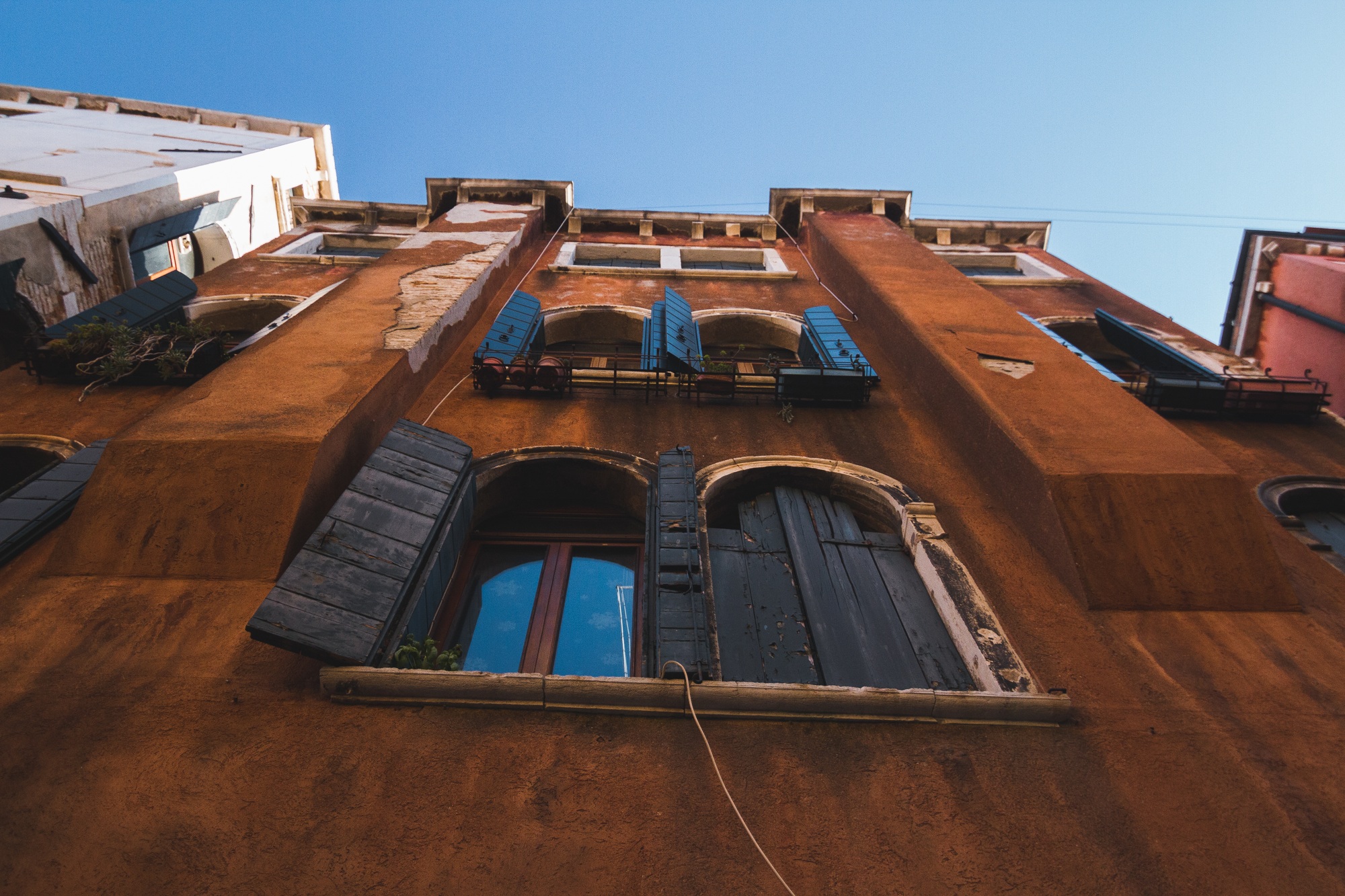 Low angle shot of an apartment with windows in Italy